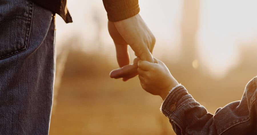 Fathe and son holding hands